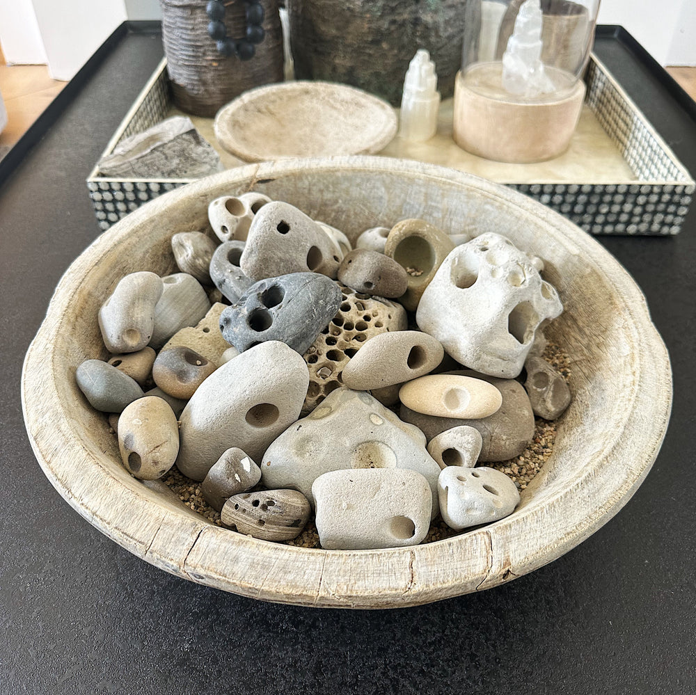 
                  
                    Antique wooden bowl with gathered rocks from the beach
                  
                